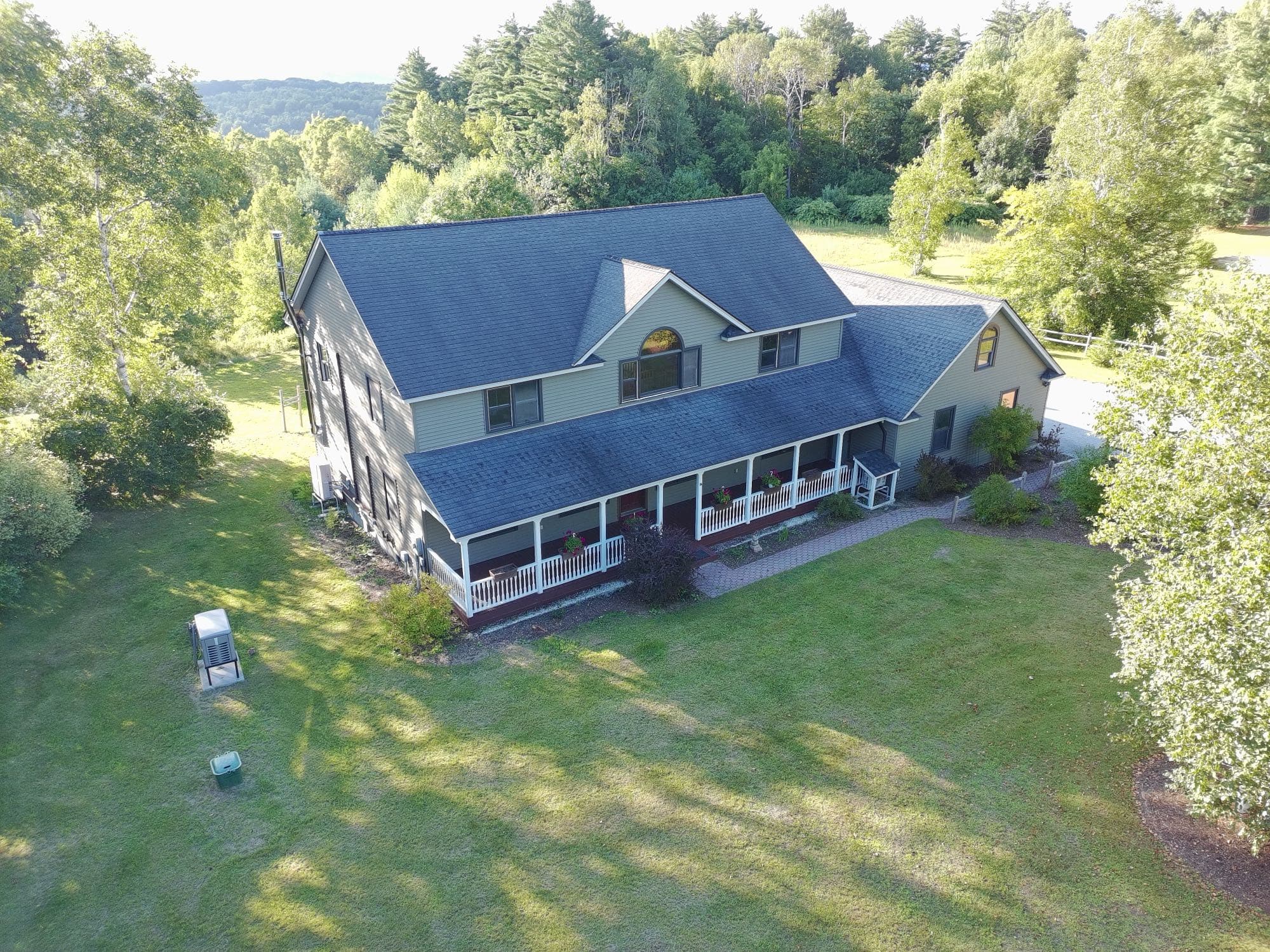 Overhead drone photo of a property's roof and lot boundaries