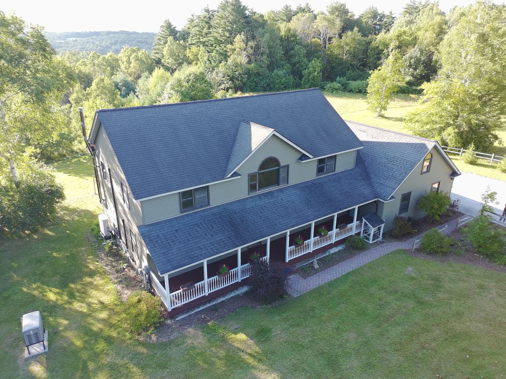 Aerial real estate shot of a Vermont home in its natural setting